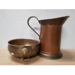BRASS AND COPPER JUG TOGETHER WITH A BRASS CENTRE BOWL WITH LION HEAD HANDLES