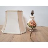 A MOORECROFT HIBISCUS TABLE LAMP ON CREAM BACKGROUND