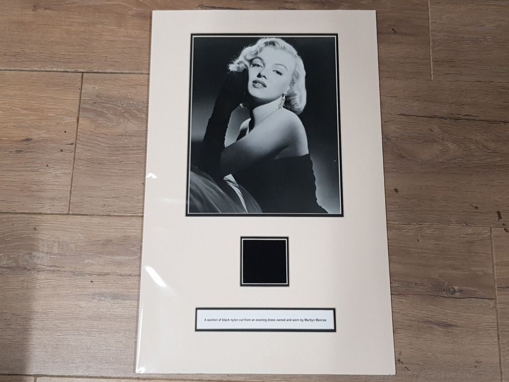 MARILYN MONROE CUT PIECE OF A BLACK EVENING DRESS WORN BY HER, ACCOMPANIED BY A LETTER OF