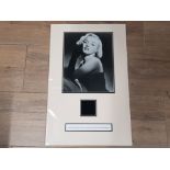 MARILYN MONROE CUT PIECE OF A BLACK EVENING DRESS WORN BY HER, ACCOMPANIED BY A LETTER OF