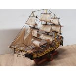 HMS VICTORY MODEL SHIP WITH 5 POUND TRAFALGAR COIN BUILT INTO STAND 46CM HEIGHT X 47CM LENGTH
