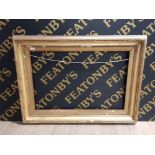 A LARGE GILT PICTURE FRAME 118CM BY 87CM