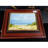A FRAMED ACRYLIC ON BOARD OF A NORTH EAST BEACH AND SEA SCENE SIGNED T MCARDLE
