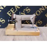 A VINTAGE SINGER SEWING MACHINE WITH ORIGINAL CARRY CASE