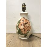 A MOORECROFT HIBISCUS PATTERNED TABLE LAMP ON CREAM BACKGROUND