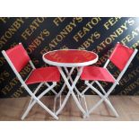 A LOVELY MODERN RED AND WHITE CIRCULAR TOPPED FOLDING TABLE AND 2 MATCHING CHAIRS