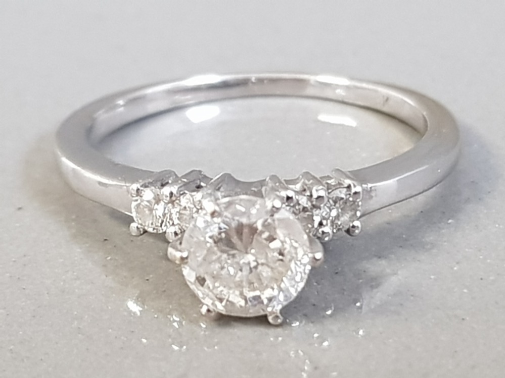 18CT WHITE GOLD DIAMOND SOLITAIRE RING WITH TWO DIAMONDS ON EACH SHOULDER APPROXIMATELY. 75CT 2.9G