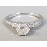 18CT WHITE GOLD DIAMOND SOLITAIRE RING WITH TWO DIAMONDS ON EACH SHOULDER APPROXIMATELY. 75CT 2.9G