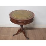 A 2 DRAWER LEATHER CIRCULAR TOPPED DRUM TABLE ON PEDESTAL BASE WITH LION PAW FEET