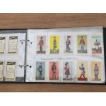 ALBUM CONTAINING 7 CIGARETTE CARD COLLECTIONS INCLUDES 1966 BARRATT SOLDIERS, BRADSHAW TEA 1971