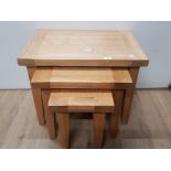 A NEST OF 3 SOLID OAK TABLES