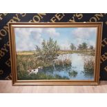 GILT FRAMED OIL ON CANVAS WATERSIDE SCENE WITH SPRINGER SPANIEL RETRIEVING DUCK SIGNED SVEND JENSEN