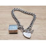 SILVER CURB BRACELET WITH HEART LOCK CLOSURE SAFETY CHAIN AND OLD SILVER CHARM CONTAINING £1 NOTE