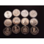 COLLECTION OF 12 DIFFERENT COMMEMORATIVE CROWN SIZE COINS FROM THE COMMONWEALTH HOUSED IN