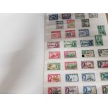 STAMP ALBUM CONTAINING A LARGE QUANTITY OF LOOSE COMMONWEALTH STAMPS NIGERIA, CEYLON AND FIJI ETC