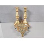 A PAIR OF INVERTED BEEHIVE PUSH ROD BRASS CANDLESTICKS TOGETHER WITH AN ANTIQUE BRASS TRIPOD TRIVET