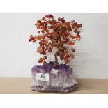 AN AMETHYST QUARTZ BASE WITH A WIREWORK TREE COVERED IN POLISHED AMBER GEMSTONES AS LEAVES