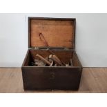 A VINTAGE WOODEN TOOLCHEST CONTAINING A LOT OF MISCELLANEOUS TOOLS SUCH AS HAMMERS CHISELS ETC