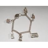 HALLMARKED SILVER CHARM BRACELET WITH 7 CHARMS, TELEPHONE BOX, DOUBLE DECKER BUS AND LOVE HEART LOCK