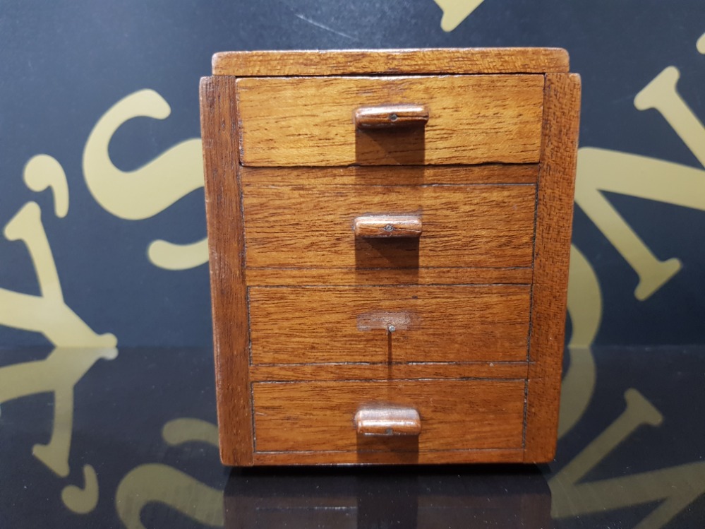 A MID 20TH CENTURY MAHOGANY MONEY BOX WITH SLIDE HINGED RECEIVER IN THE FORM OF A CHEST OF DRAWERS