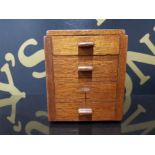 A MID 20TH CENTURY MAHOGANY MONEY BOX WITH SLIDE HINGED RECEIVER IN THE FORM OF A CHEST OF DRAWERS