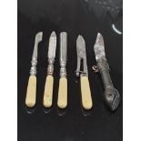 A 4 PIECE ANTIQUE POLISHED STEEL MINIATURE MANICURE SET WITH IVORY COLOURED HANDLES TOGETHER WITH