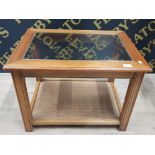 A MODERN LAMP TABLE WITH BEVELLED GLASS TOP AND RATTAN COVERED UNDER TIER 66CM WIDE TOGETHER WITH