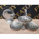 A PAIR OF PIERCED METAL THREE TIER FOLDING CAKE STANDS TOGETHER WITH A SILVER PLATED BON BON