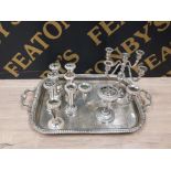 A LARGE TWIN HANDLED SILVER PLATE SERVING TRAY CONTAINING CANDELABRAS CANDLESTICKS ETC