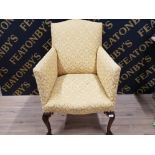 UPHOLSTERED AND METATAL STUDDED EDWARDIAN FIRESIDE CHAIR WITH MAHOGANY CABRIOLE LEG SUPPORTS