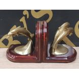 A PAIR OF BRASS AND WOODEN DOLPHIN BOOKENDS