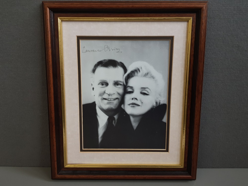 LAWRENCE OLIVIER SIGNATURE IN SILVER ON A BLACK AND WHITE PHOTOGRAPH OF OLIVIER AND MARILYN MONROE
