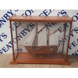 A 2 MASTED WOODEN MODEL OF THE FALCON SAILING SHIP IN NICELY PRESENTED DISPLAY CASE 72CM BY 24CM