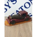 HANDCARVED AND PAINTED MODEL CAR ON PLINTH