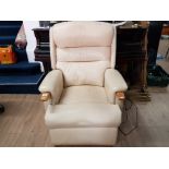 A MODERN CREAM LEATHER UPHOLSTERED RECLINING ARMCHAIR