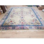 A LARGE PERSIAN STYLE RUG WITH FLORAL MOTIFS ON PALE GREEN GROUND 360 X 276CM