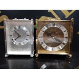 TWO QUARTZ BRASS CARRIAGE CLOCKS, 1 SILVERED