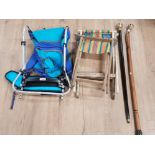 TWO WALKING STICKS WITH BRASS HANDLES A PAIR OF FOLDING OUTDOOR SEATS AND A TOMY BABY CARRIER