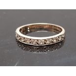 A 9CT YELLOW GOLD AND DIAMOND HALF ETERNITY RING CONTAINING 9 DIAMONDS STAMPED 375 SIZE Q 1/2 2G
