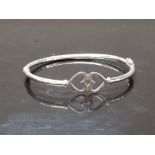 A SILVER TWIN HEARTS BANGLE STAMPED 925