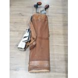 A VINTAGE GOLF BAG CONTAINING CLUBS