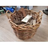 A VERY LARGE WICKER LOG BASKET WITH CONTENTS 76CM DIAMETER