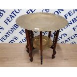 A MIDDLE EASTERN TWO TIER BRASS AND WOOD OCCASIONAL TABLE 60CM DIAMETER