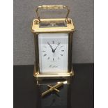 WOODFORD BRASS MECHANICAL CARRIAGE CLOCK WITH KEY AND BOX