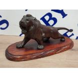 A VERY NICE FIGURED ORNAMENT OF A BRONZE LION STOOD ON A NICELY CARVED PLINTH 1FT IN LENGTH