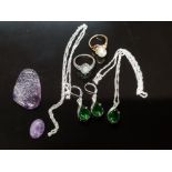 A SILVER COLOURED PENDANT ON SILVER CHAIN AND MATCHING EARRINGS WITH GREEN PASTE STONES TWO DRESS