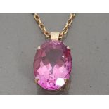 9CT YELLOW GOLD PINK OVAL STONE PENDANT AND CHAIN, 6.3G