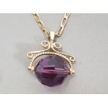 9CT YELLOW GOLD PURPLE STONE FOB STYLE PENDANT AND CHAIN, 9.4G
