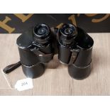 A PAIR OF WWII GERMAN 10 X 50 BINOCULARS MARKED DIENSTGLAS WITH TOTENKOMF STAMP TO TOP RIGHT PLATE (
