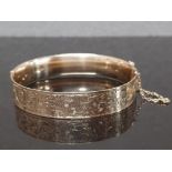 9CT GOLD WITH BRONZE CORE BANGLE, BY LAWSON WARD AND GAMMAGE LAGARMIC WITH SAFETY CHAIN, 65MM X 55MM